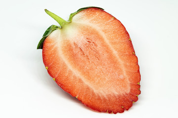 Strawberry in close-up. Red, ripe fruit on a white background. Spring natural food. The first spring delicacies.