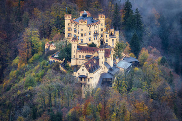Fototapeta na wymiar Hohenschwangau bavarian castle old yellow building aerial view with a beautiful fog on the forest in autumn season