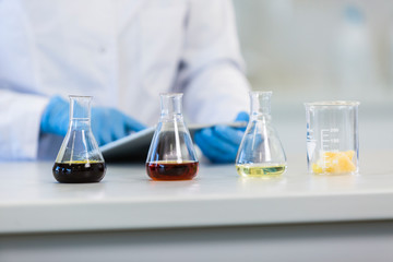 Scientist’s hands working with tablet in cbd laboratory