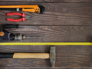Work tools with helmet and gloves on wooden background