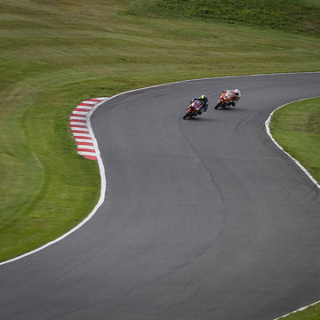 A shot of two racing bikes speeding round corners