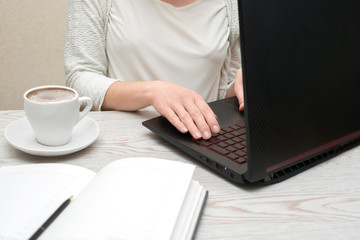 Distance learning online education and freelance work. Woman girl working office work remotely from home. Using computer and drinking coffee.