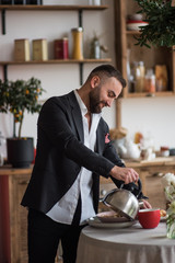 man on the kithen make tea, cooking and smile