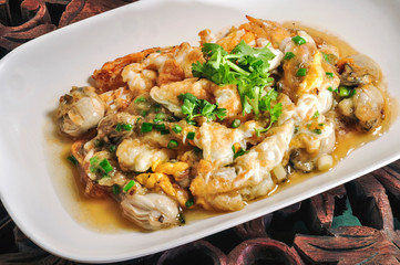 Oyster Omelet in a white plate on a wooden table
