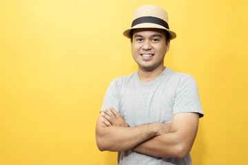 A handsome man in a good mood standing on a yellow background