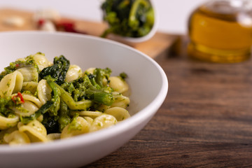 Typical dish of Italian cuisine, orecchiette with turnip greens. Orecchiette with cime di rapa, vegan food, healthy dish, fast lunch.