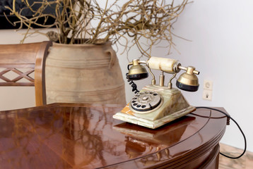 Old, stone phone is on the table close-up