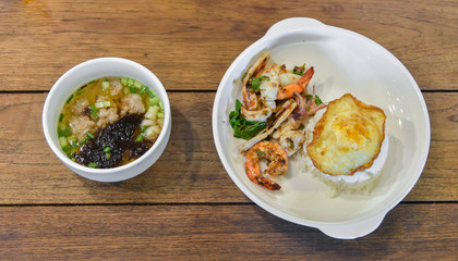High angle view of Thai food dish, Rice topped with stir-fried seafood and basil