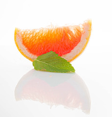 orange slice with mint leaves on white