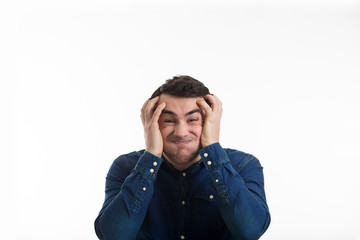 Nervous man holding hands inon his head about to have nervous atomic breakdown  isolated on white background. Human expression concept.