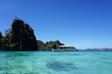 High, rocky stones and turquoise lagoon in Philippines