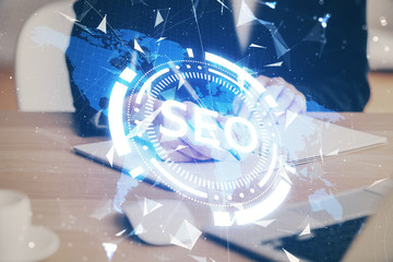 Multi exposure of woman's hands making notes with SEO icon. Concept of Search engine optimization