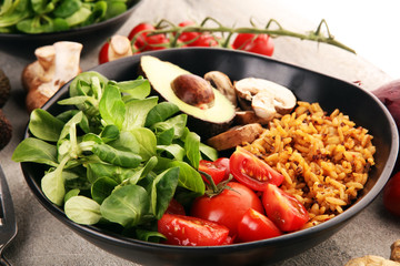 Healthy vegan salad bowl with quinoa, tomatoes, avocado and mixed greens, lettuce. Food and health bowl