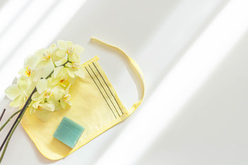 Glove kese and bath soap on white background. Hammam and spa concept. Top view, flat lay, copy space.