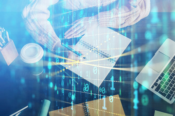 Double exposure of writing hands on background with data solution hologram on front. Technology concept. Close up