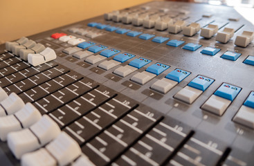 Sound mixer control panel with sliders and buttons closeup. Selective focus.