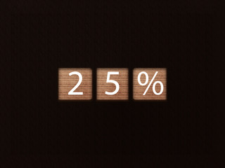 The inscription 25% on wooden blocks on black background. Letter text on wooden cube.