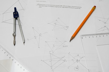 Technical drawing table with pencil, drafting compass, rulers, paper