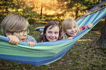 Fototapeta na wymiar friends in a hammock are having fun on a sunny day