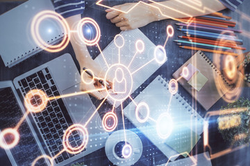 Social network theme hologram over woman's hands writing background. Concept of international people connect. Double exposure