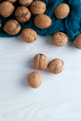 walnuts on a blue cloth and a wooden table