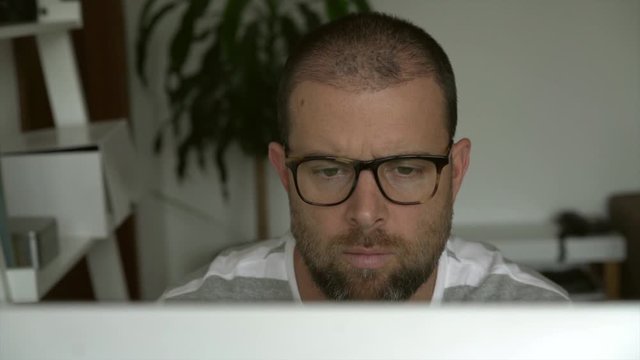 Man working on a computer from home