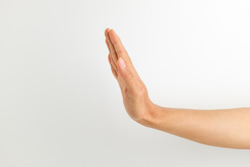 Hand signal expressing stop on white background