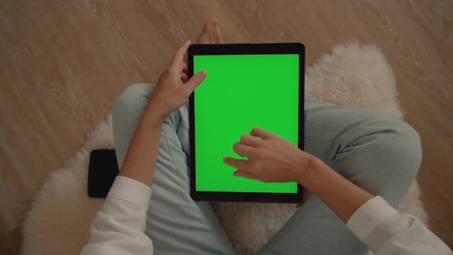 Woman scrolling through interent using tablet Chroma key