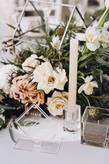 Stylish wedding floristics. Banquet tables decorated with arrangements of flowers, herbs and candles