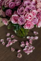 Still life close-up bouquet on the table romantically close-up. Pink roses are beautiful vibrant petals. Background for postcards art photo. Romance tenderness gift surprise elegant. Flowers at home. 