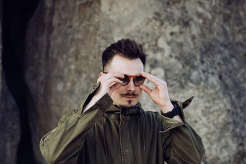 Obraz premium Lifestyle portrait of young hipster man in sunglasses outdoors