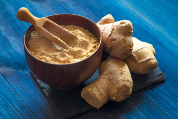 Ginger powder and ginger root. Food photo concept.