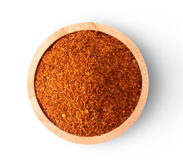 chili pepper powder in wood bowl on white background