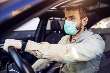Fototapeta na wymiar Man with protective mask and gloves driving a car. Infection prevention and control of epidemic. World pandemic. Stay safe.