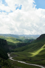 mountain green landscape of mountain slopes on a cloudy summer day