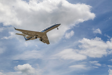 Travel concept. Commercial airplane jetliner flying above dramatic clouds in beautiful light.