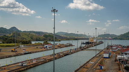 Fototapeta na wymiar Huge ship is moving transportation over Panama Canal. Panama City and water transport. 