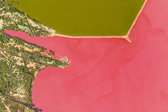 Aerial drone top-down photo of a beautiful natural pink lake located in Torrevieja, Spain. The lake turning into pink by a natural phenomenon and because it has high concentration of salt and algae