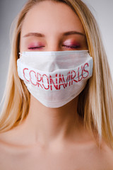 Studio portrait of young woman wearing a face mask, looking at camera.