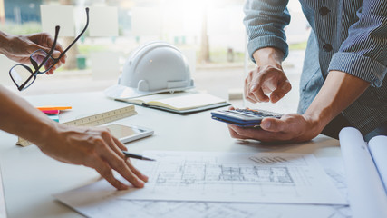 Cooperation Corporate designers in the office are working on a new project Planning blueprint Design at construction site at desk in office.