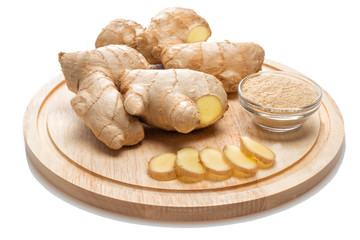 ginger, sliced root, dried ginger in glass bowel on wooden cutting board isolated on white background