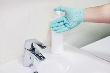 Washing hands with sanitizer man for covid-19 prevention in hospital. Cleaning to stop spreading corona virus. Health care and hygiene concept.