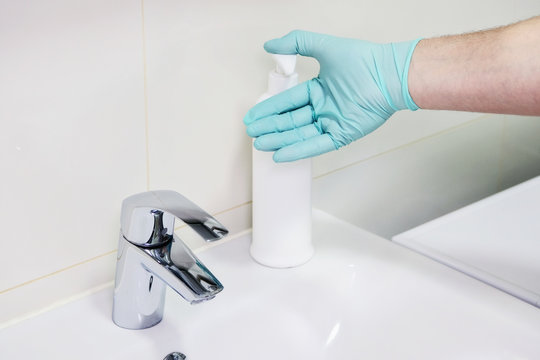 Washing hands with sanitizer man for covid-19 prevention in hospital. Cleaning to stop spreading corona virus. Health care and hygiene concept.