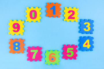 Colorful kids numbers toys on blue background. Place for design. Education concept. Creative concept. Flat lay, copy space, top view.