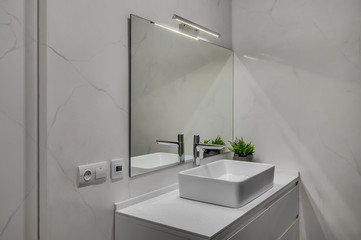 Interior of a modern loft style apartment. Marble bathroom