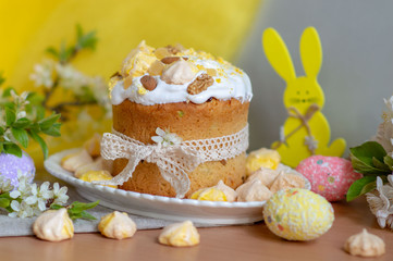 Traditional Easter treats Easter cake decorated with icing meringues and Almond nuts on a table...