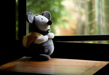 Teddy mouse stand on wood table in bedroom,stay at home