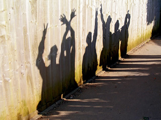 Happy shadows on a fence.