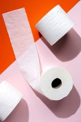 white toilet paper rolls on colored backgrounds