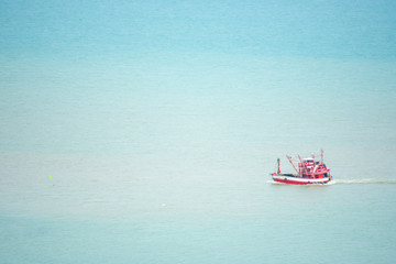 Fishing boats sailing in the sea without waves.